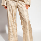 Бежевые шелковые пижамные штаны с монограммой от Toteme